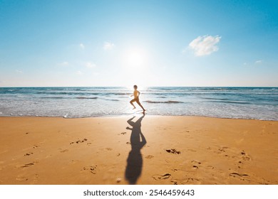 Active man jogging. Healthy lifestyle. a man runs barefoot along the beach by the sea. A young runner runs along an empty beach at dawn. run near the sea. - Powered by Shutterstock