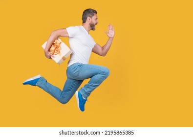 Active man running to deliver present box. Delivery boy in midair. Express delivery service. Fast delivery