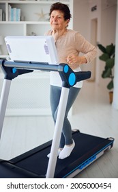 Active Mature Woman Running On Treadmill At Home, Sporty Lifestyle, 84 Years Old Lady