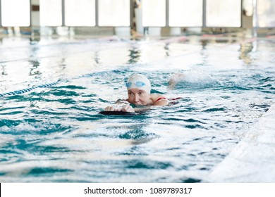 Active mature woman in swimwear swimming and exercising in water at lesiure - Shutterstock ID 1089789317