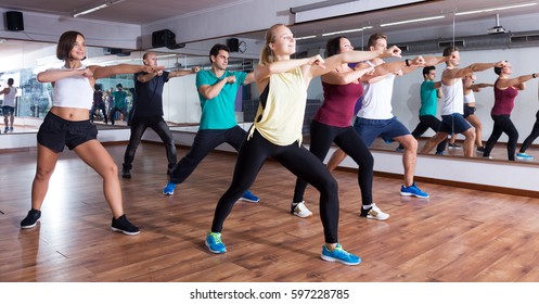 Active men and ladies dancing  at lesson