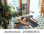 Active, men and warm up exercise at house with holistic fitness, spiritual healing and mindfulness. Above, people and stretching for pilates, mental health and performance peace with wellness balance