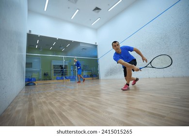 Active men working out engaging in friendly squash matches