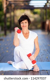 Active Middle Aged Woman Exercise With Dumbbells