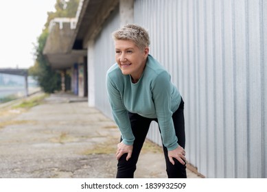 Active Middle-aged Woman Cooling Down After Running