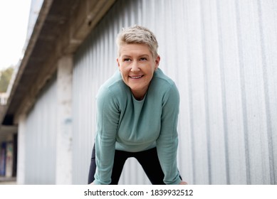 Active Middle-aged Woman Cooling Down After Running