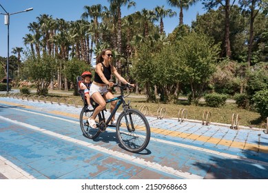 Active Mother And Child Riding A Bike Together On Outdoors Background. Caucasian Woman And Baby Boy On A Bicycle.