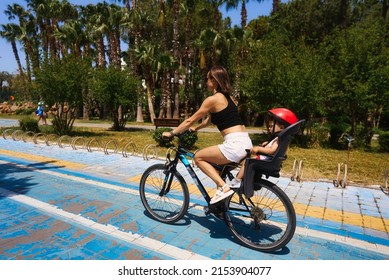 Active Mother And Child Riding A Bike Together On Outdoors Background. Caucasian Woman And Baby Boy On A Bicycle.