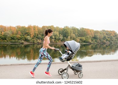 Active Mother Jogging. Jogging Or Power Walking Woman With Pram At Sunset. Mother With Child In Stroller Running