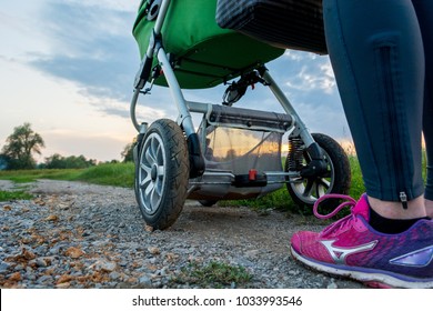 Active Mother Running With Baby Stroller.