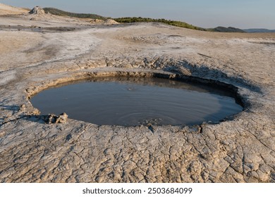 Active mud volcano in Berca, Buzau, Romania. These small, volcano-shaped mounds, usually a few meters tall, result from deep volcanic gas eruptions.