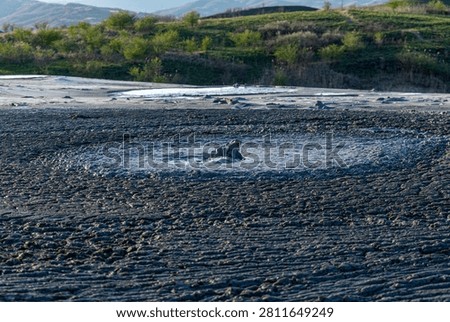Active mud volcano erupting gas and liquid clay