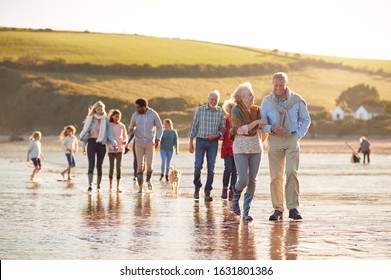 Active Multi-Generation Family With Dog Walking Along Shore On Winter Beach Vacation - Powered by Shutterstock