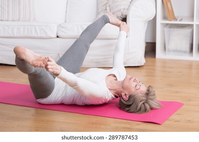 Active Older Woman And Her Morning Gymnastic At Home