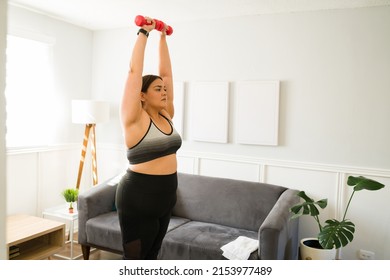 Active Overweight Woman Lifting Dumbbell Weights During Her Home Cardio Workout