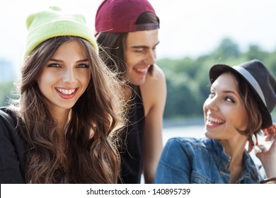 Active people. Closeup of group of young two women and one man. Outdoors, lifestyle