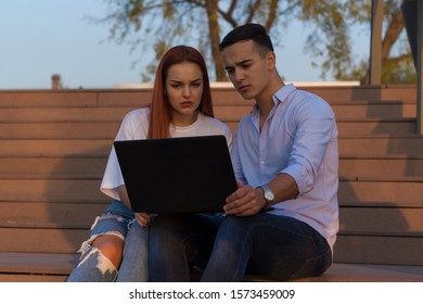 Active People. Photo Of Group Of Young Bussines Couple Looking At Laptop Computer. Happy Students Using Laptop Outside.