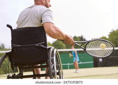 An active person who uses a wheelchair engaging in a tennis game outdoors, exemplifying inclusion and determination. - Powered by Shutterstock