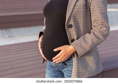 Active Pregnancy Concept. Close-up Of Belly Of Young Business Or Student Pregnant Woman. Future Mom Working Or Studying On Her Late Pregnancy Period.