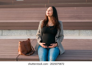 Active Pregnancy Concept. Happy Young Business Or Student Pregnant Woman Sitting On The Bench. Future Mom Working Or Studying On Her Late Pregnancy Period.