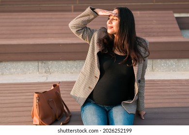 Active Pregnancy Concept. Happy Young Business Or Student Pregnant Woman Sitting On The Bench. Future Mom Working Or Studying On Her Late Pregnancy Period.