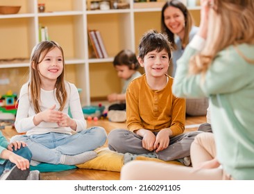 Active Preschool Children Interacting With Their Teacher. Teacher-child Relationships – Early Learning.  Healthy Learning Environment