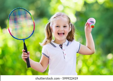 Active Preschool Girl Playing Badminton In Outdoor Court In Summer. Kids Play Tennis. School Sports For Children. Racquet And Shuttlecock Sport For Child Athlete. Kid With Racket And Shuttle