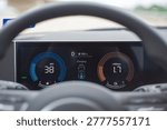 Active Regenerative Braking Telemetry. Dash panel monitors 38 mph velocity alongside battery charging algorithms. Bright azure rings contrast beautifully behind shadowed cabin focal points. USA