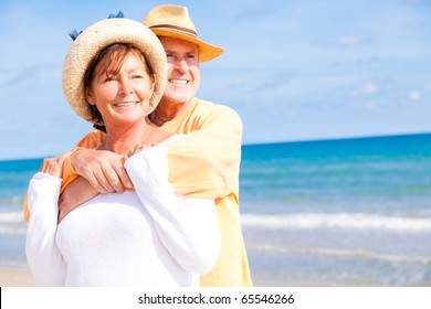 active Relaxed summer vacation senior couple of old man and woman standing on the beach
