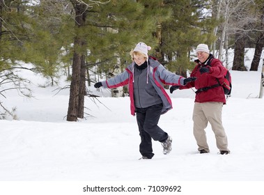 Active Retired Couple Walking In The Snow