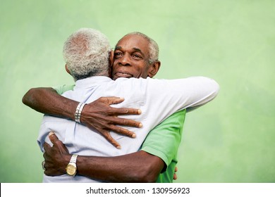 Active retired old men and leisure, two senior black brothers hugging outdoors