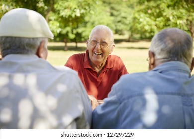 Active Retired Senior People, Old Friends And Leisure, Group Of Three Elderly Men Having Fun, Laughing And Talking In City Park. Waist Up