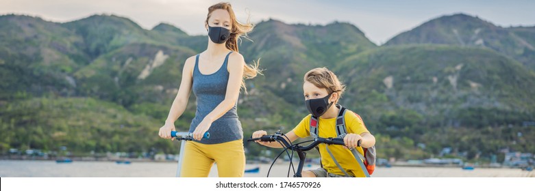 Active School Kid Boy And His Mom In Medical Mask Riding A Bike With Backpack On Sunny Day. Happy Child Biking On Way To School. You Need To Go To School In A Mask Because Of The Coronavirus Epidemic