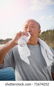 An Active Senior Asian Man Drinking Water After Exercise