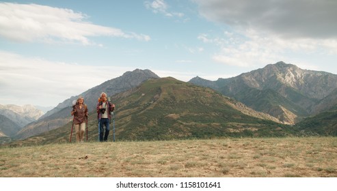 Active Senior Caucasian Couple Hiking In Mountains With Backpacks, Enjoying Their Adventure 4k