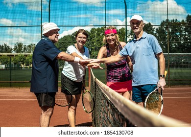 Active senior Caucasian couples in sportswear playing tennis,  greet each other before the match - Powered by Shutterstock