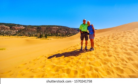 Active Senior Couple Hiking The Sand Dunes In The Coral Pink Sand Dunes State Park Along Vermilion Cliffs In Kanab County In Utah, United States