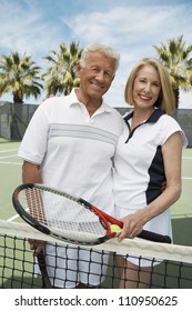 Active Senior Couple On The Tennis Court