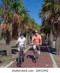 Active Senior Couple Riding Bikes On Their Florida Vacation.