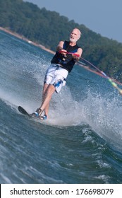 An Active Senior Demonstrates His Super Fitness On A Waterski.