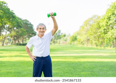 active senior man doing exercise with dumbbell outdoors in the nature park,elderly lifestyle,workout activity,health benefit in nature