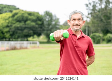 active senior man doing exercise with dumbbell outdoors in the nature park,elderly lifestyle,workout activity,health benefit in nature