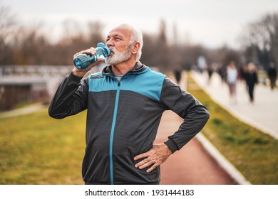 Active Senior Man Is Drinking Water After Exercising. Healthy Lifestyle.