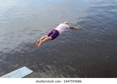 Active Senior Man On Diving Board