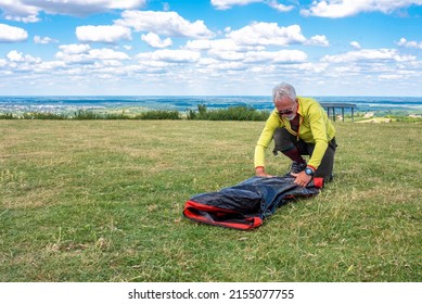 Active senior man setting up the tent in high mountains. Camping and travel concept. - Powered by Shutterstock