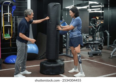 active senior man train boxing with a person with prosthetic leg,a healthy artificial leg trainer teaches elderly boxing for exercise,health,athletic - Powered by Shutterstock