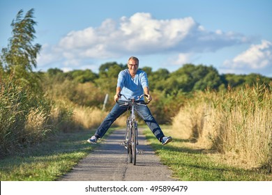 Active senior on bike in spring nature, Senior with his bicycle                                