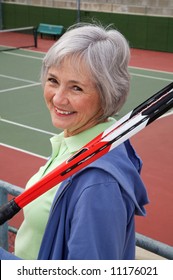 Active Senior On The Tennis Court.