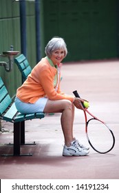 Active Senior On The Tennis Court.