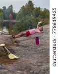 Active senior relaxes while on a kayaking and camping trip on Georgian Bay in Ontario, Canada.